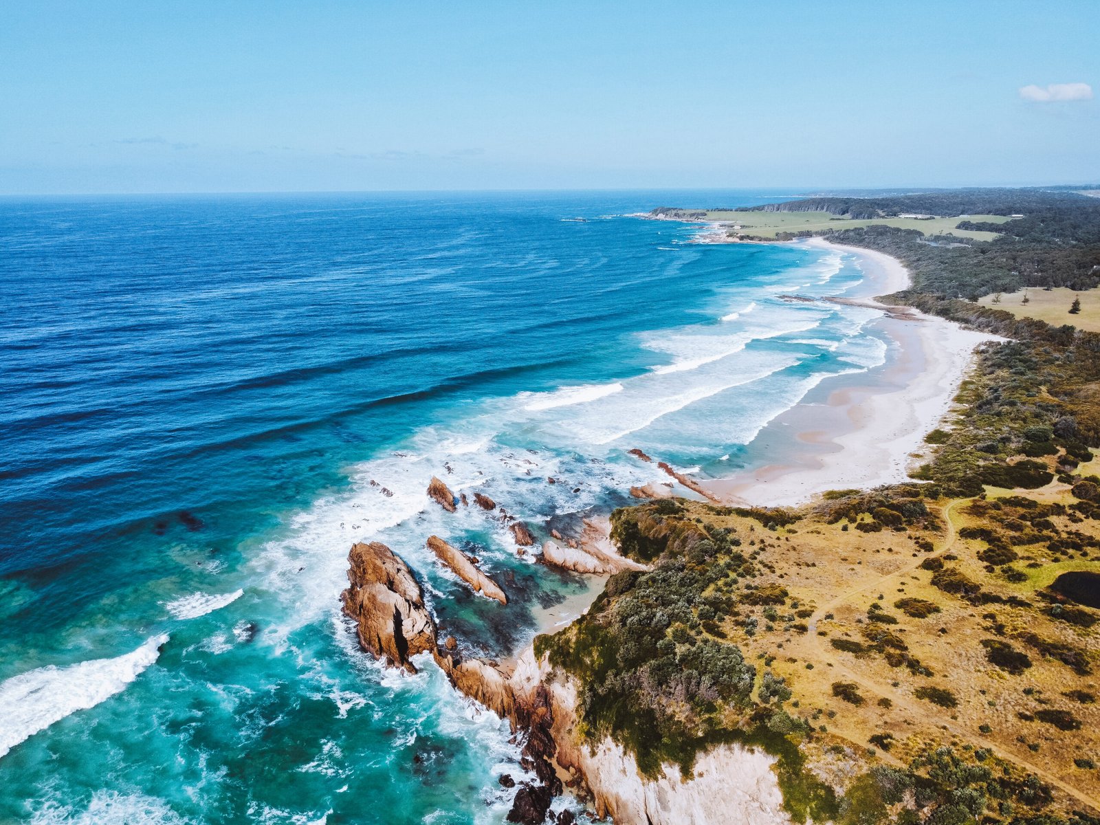 Aerial view of Narooma coastline and blue water in New South Wales